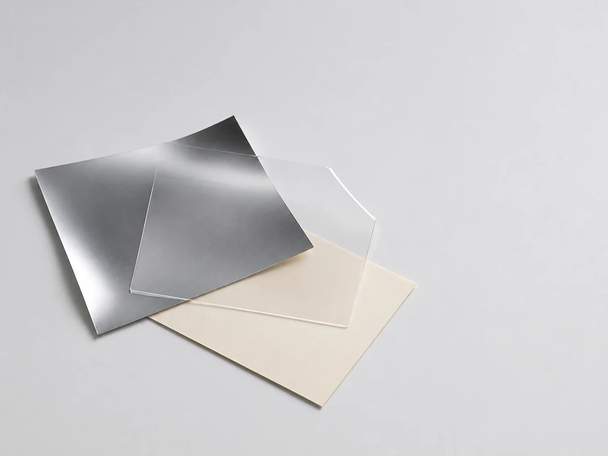 Illustrative unbranded metallized film, transparent film and paperboard material study for a lamination discussion.